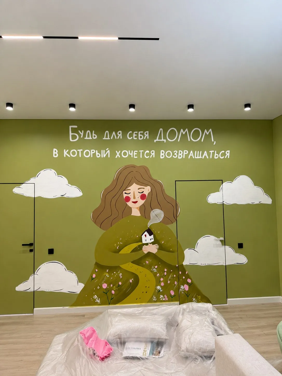 Девушка в зелёном платье и цитата на стене